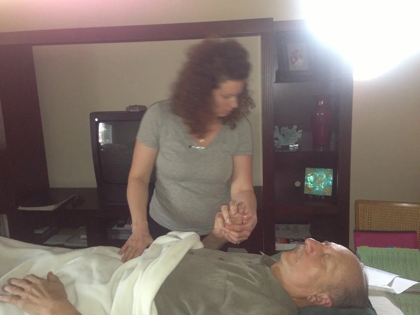 Woman comforting a patient in bed