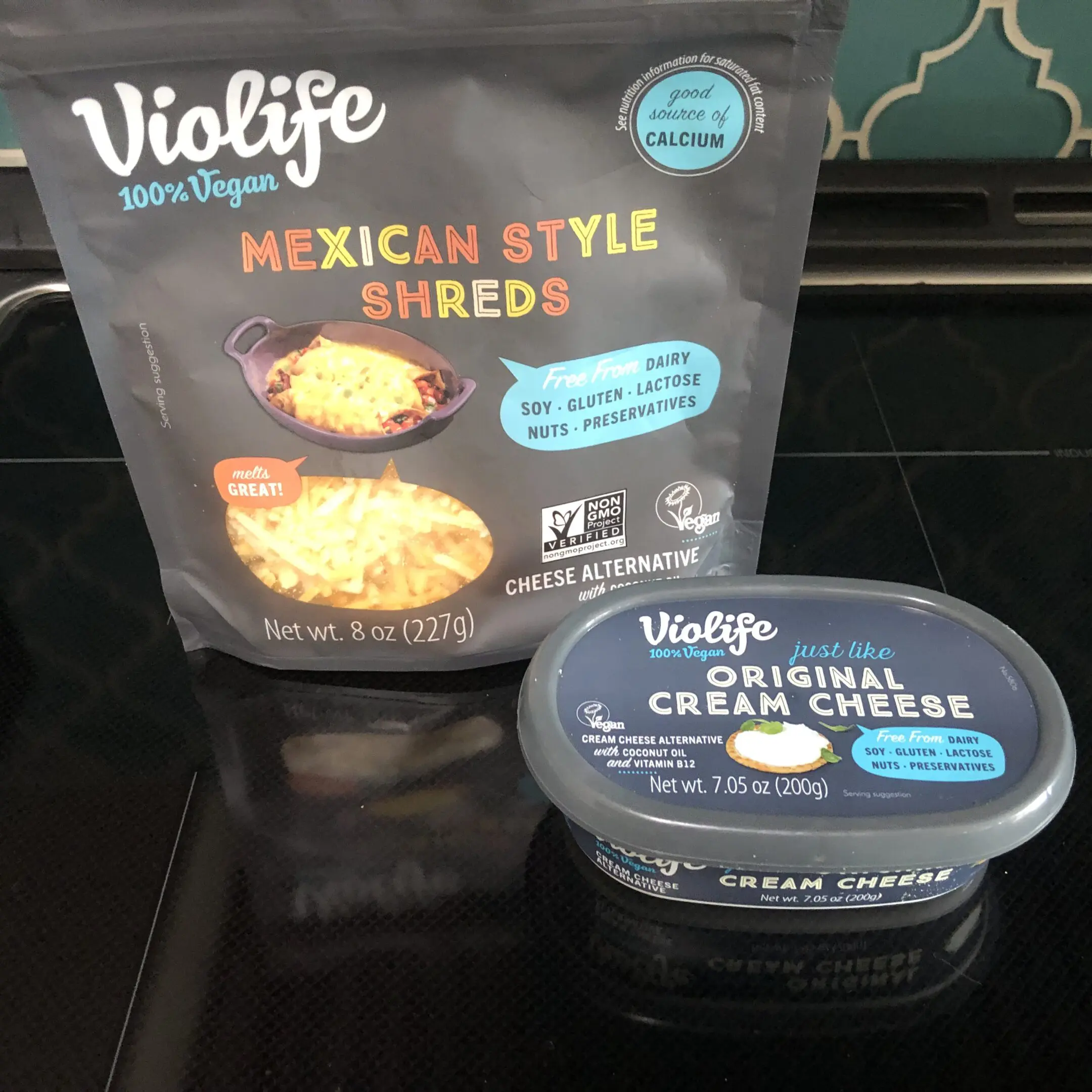 Violife Mexican Style Shreds and Cream Cheese on a kitchen counter.