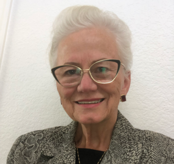 Woman with white hair and glasses