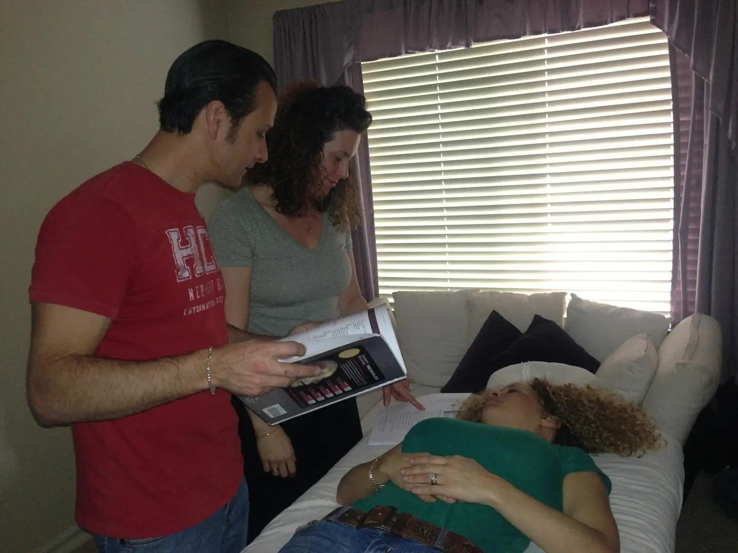Man and woman reading by patient